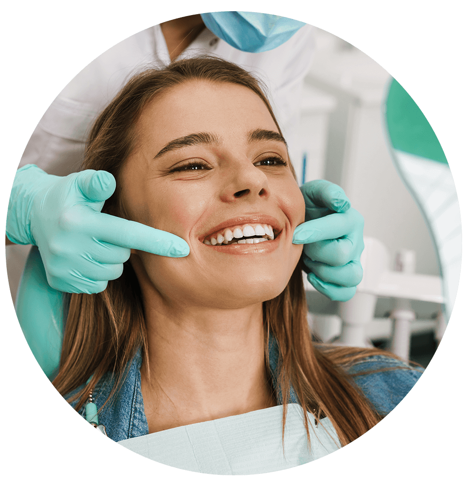 young woman smiling while looking at mirror in dental clinic