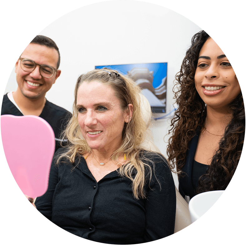 Patient and doctor smiling into mirror