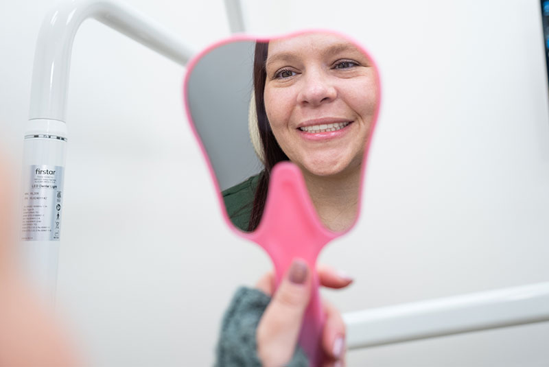 Patient looking into mirror after AOX procedure