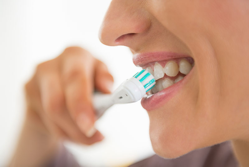 woman brushing her teeth